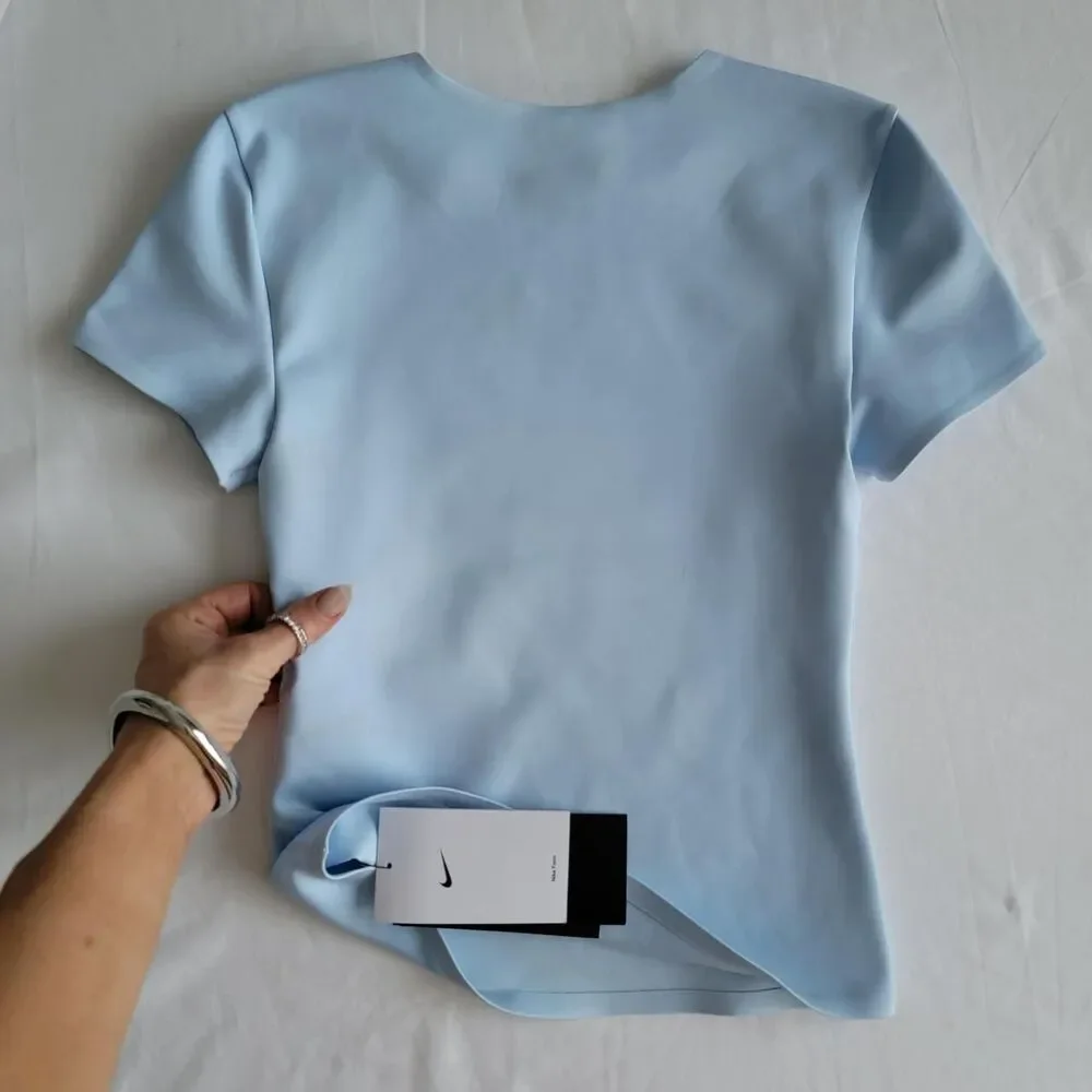 NWT NIKE FORM women's training top in baby blue, size xxs.